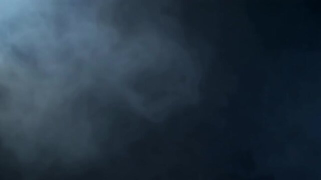 Soft white smoke swirls on black.
