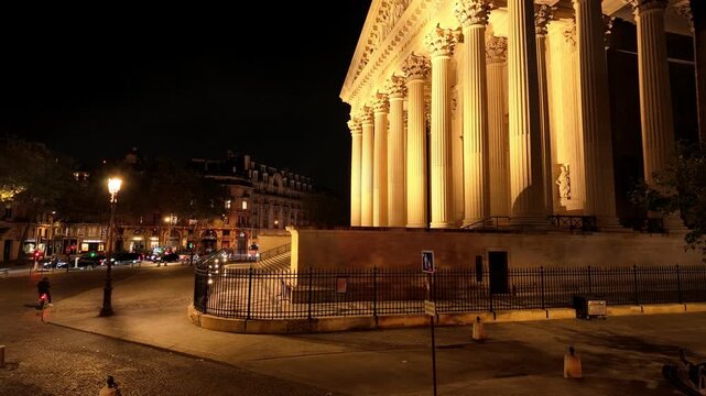 Pantheon, a Neoclassical building, glowing under spotlights at night in Paris