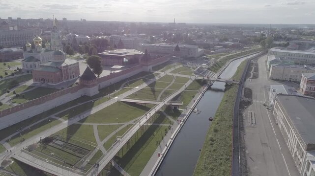 Drone flies down the embankment toward park bridges in Tula