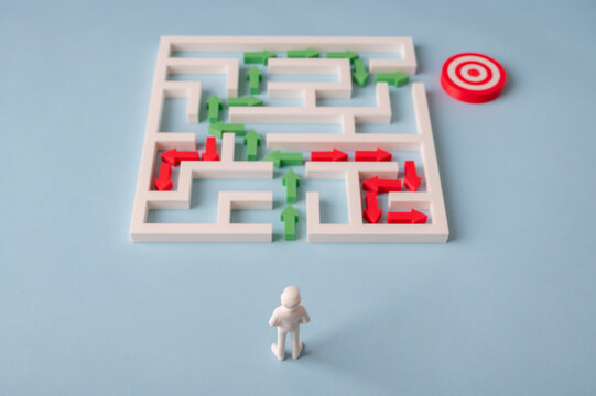 Businessman choosing the correct route through maze while avoiding dead ends