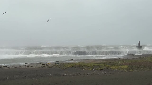 Rough Sea Waves Crash Into Sea Wall During Storm