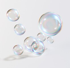 Obraz premium Colorful iridescent soap bubbles floating against white background