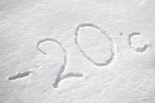Background with snow, photo of snow texture in winter and numbers indicating that the temperature is -20 degrees Celsius