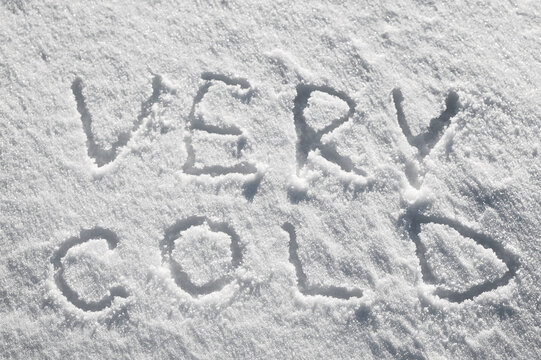 Snow background, photo of snow texture in winter and letters indicating it is very cold
