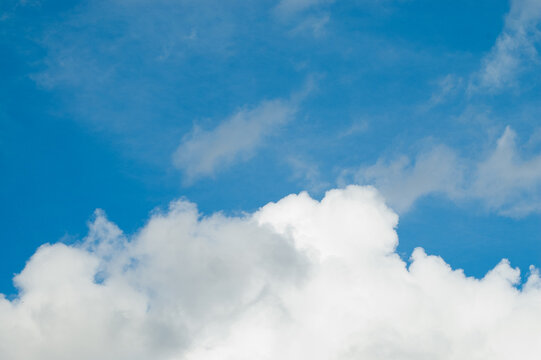The photo shows a blue sky and clouds
