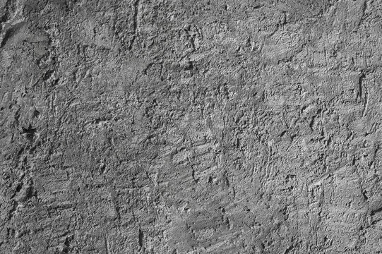 Gray background, photo of the texture of an old wall with various lines, embossing, and brushstrokes