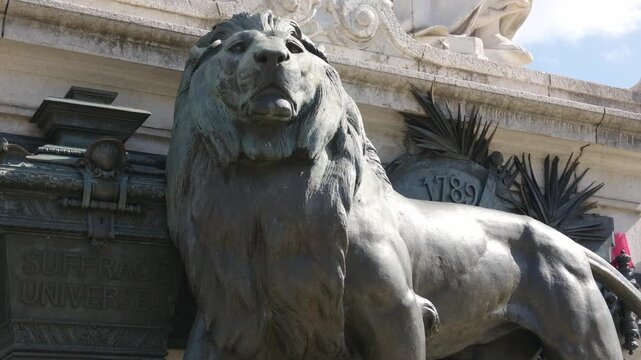 Bronze lion sculpture with Suffrage Universel and 1789 inscription on a monument in Paris, France