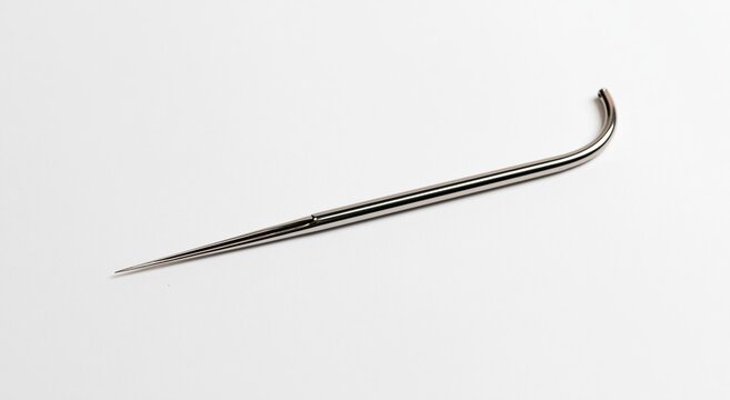 Sterile surgical needle lying on white background
