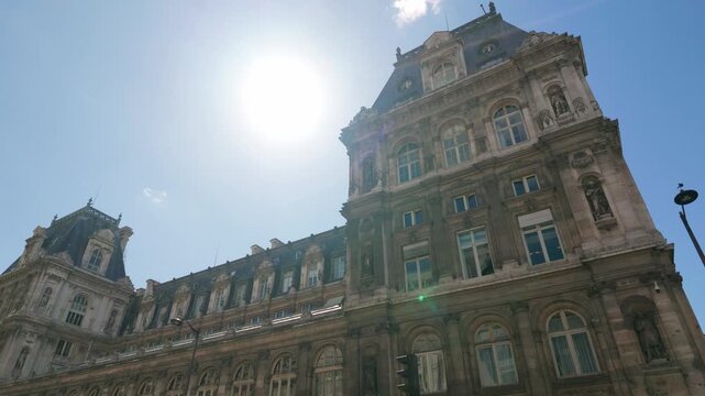 Hotel de Ville, Paris city hall building, against a clear blue sky and bright sun