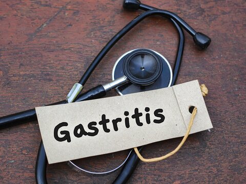 Stethoscope on wood with Gastritis word. medical concept