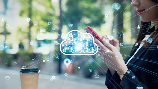 A woman using a smartphone in the city and cloud computing