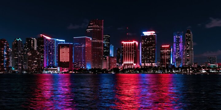 Colorful city skyline reflecting on water at night