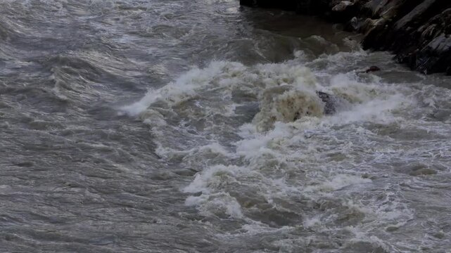 Close-up footage captures the Beas River moving swiftly through its Himalayan environment after intense monsoon rainfall in Mandi, Himachal Pradesh, India.