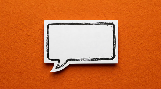 Empty speech bubble on orange felt background