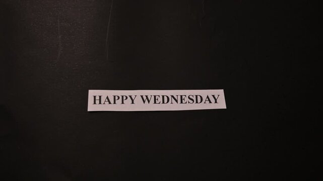 Happy Wednesday Motivation Card Placed by Hand on Dark Minimal Background