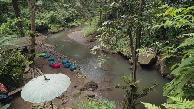 Exploring a Hidden Canyon, Rocky River and Waterfall Surrounded by Lush Tropical Forest in Bali