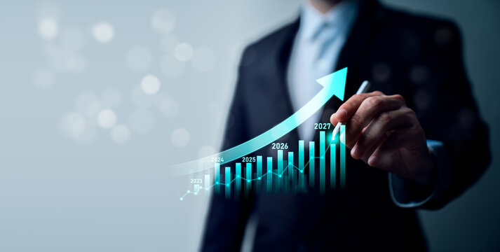 Business growth forecast concept with professional using stylus on virtual rising arrow chart showing yearly performance projection from 2023 to 2027 and future revenue strategy