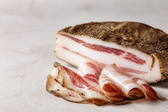 Sliced guanciale slab with rich marbled fat