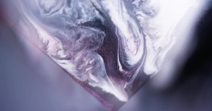 Marble paint. Shimmer mix. Defocused purple blue color sparkling triangle fluid spilling texture on abstract art background.