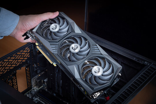 Assembly or upgrade of an expensive gaming PC or graphics workstation. Technician holding an expensive powerful MSI graphics card. Pavlodar, Kazakhstan - June 08, 2024