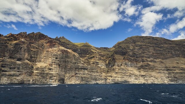 Los Gigantes, rocky coast with brown cliffs and white-blue sky over deep blue sea, whale watching boat tour, whale watching, whales, dolphins, west coast, Tenerife, Canary Islands, Spain