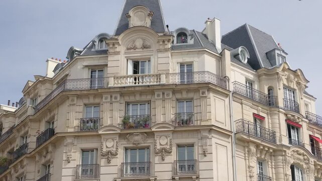 Paris Haussmann building facade featuring ornate balconies and classic European architecture
