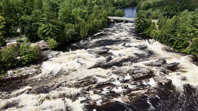 Drone flight above cascades and waterfalls park on the Ouareau River, in Rawdon, Quebec, Canada.