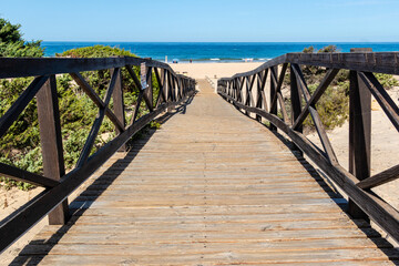 sand dunes that give access to La Barrosa beach in Sancti Petri, Cadiz, Spain © josevgluis