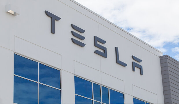 Corporate TESLA building exterior showing bold stylized lettering and modern facade elements at a commercial technology facility