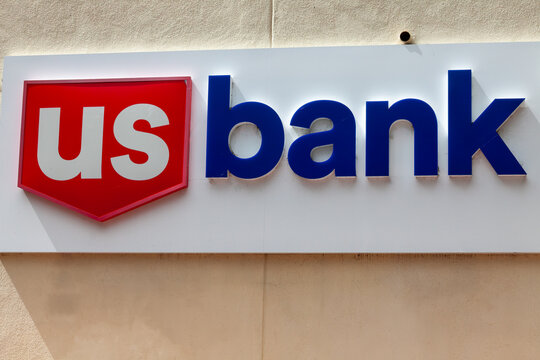 US Bank storefront signage presenting bold red‑and‑blue branding on exterior facade of financial institution