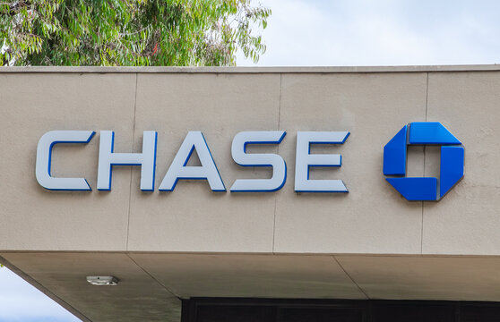 Chase Bank exterior signage displayed on beige building facade with recognizable blue logo at a commercial branch location