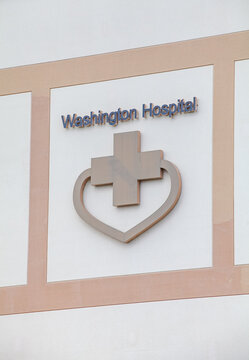 Washington Hospital signage mounted on exterior wall with cross and heart symbol identifying a major Fremont California medical facility