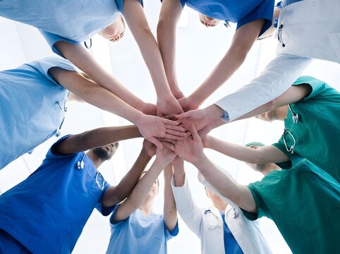 Diverse medical team joining hands in unity