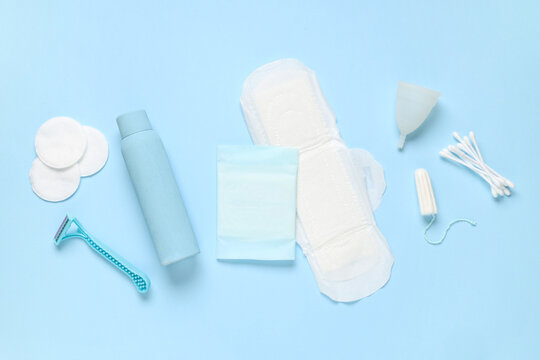 Different feminine hygiene items on blue background