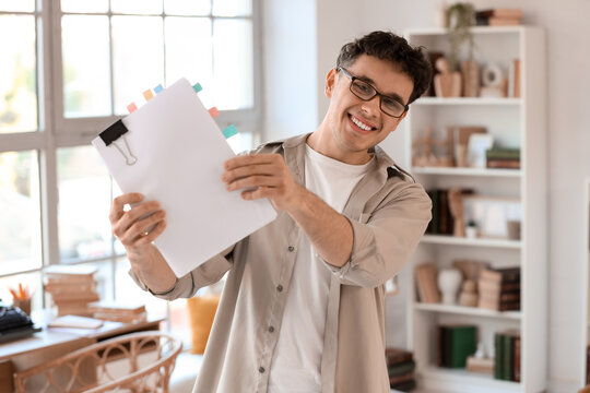 Male screenwriter with script in office
