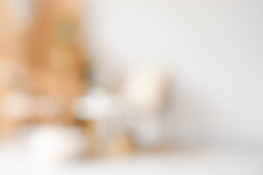 Blurred view of light room with armchairs, wooden folding screen and plants