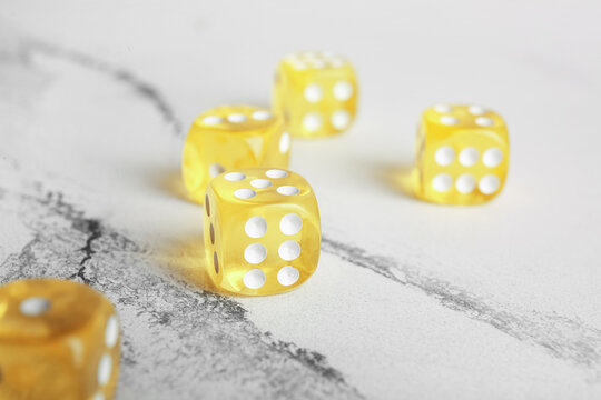Yellow dices on light background