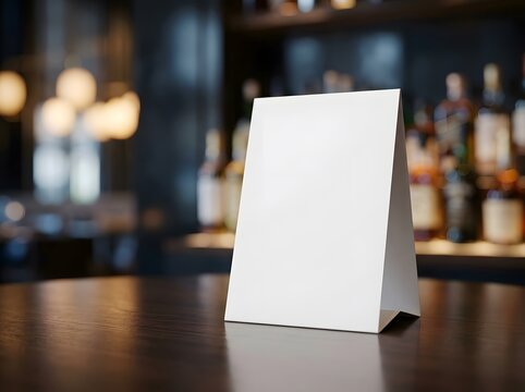 Blank white table tent menu mockup on a dark wooden bar counter