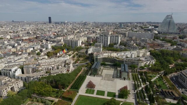 Paris cityscape with Parc Andre Citroen, Tour Triangle, and Montparnasse Tower under a clear sky