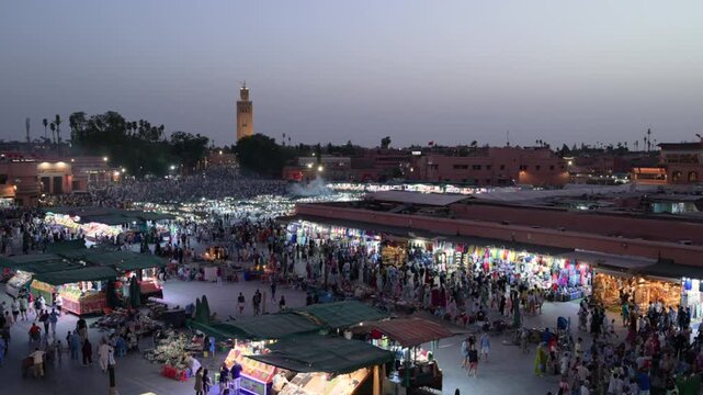 Marrakech, morocco. August 9, 2026. Bustling panoramic view of djemaa el fna square in marrakech, morocco. People crowding the famous night market with the koutoubia mosque in the background