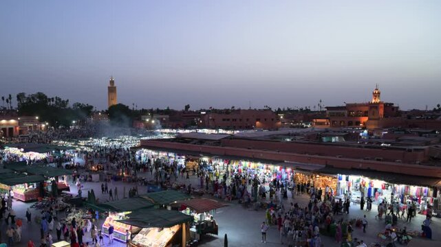 Marrakech, morocco. August 9, 2026. Bustling night market at djemaa el fna square in marrakech, morocco. Crowds of people and tourists walking among food stalls and shops