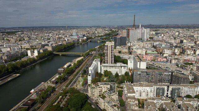 Aerial view of the Paris cityscape featuring the Seine River, buildings, and the distant Eiffel Tower