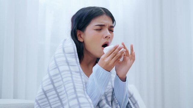 Asian woman with asthma and a cough sleeps under a blanket, has breathing difficulties in the living room, experiences chest pain, a sore throat, and tuberculosis, along with allergies