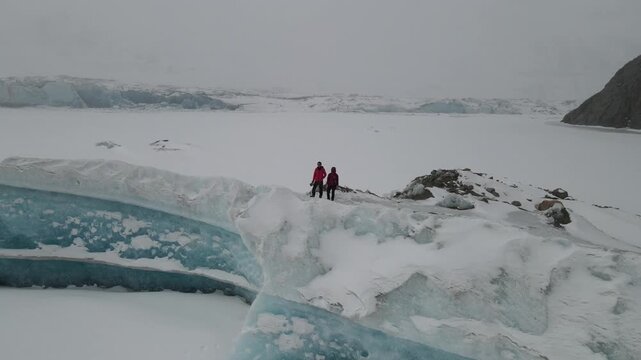 Aerial drone fly over Laigu Glacier with trekkers on ice
