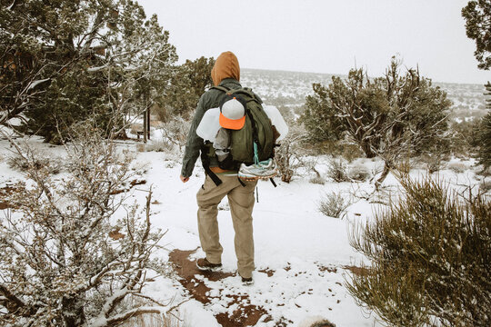Man Hiking with Backpack in Snow