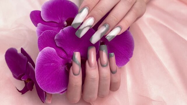 Woman's hands showing modern french manicure nail art
