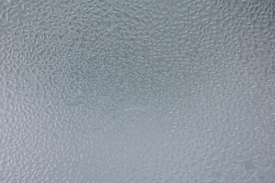 Condensing water droplets forming textured surface background