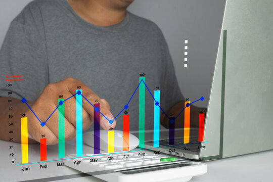 Man working on a laptop with a colorful financial bar chart and line graph overlay. Concept of business growth, data analytics, stock market investment, and corporate financial success.