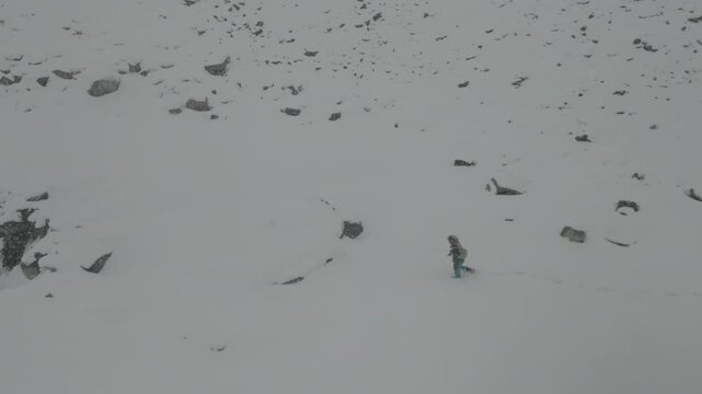 Person Struggling to Walk in Heavy Snow