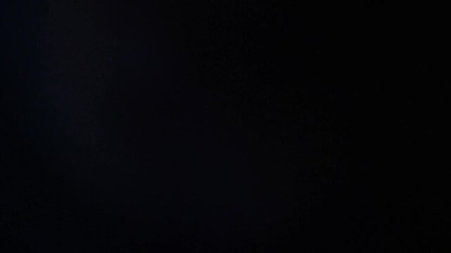 Light haze drifts subtly across a dark background creating ambient atmosphere.